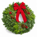 Christmas Celebration Wreath angled view with red bow, pinecones and winter berries